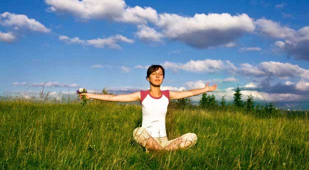 woman praising in open field