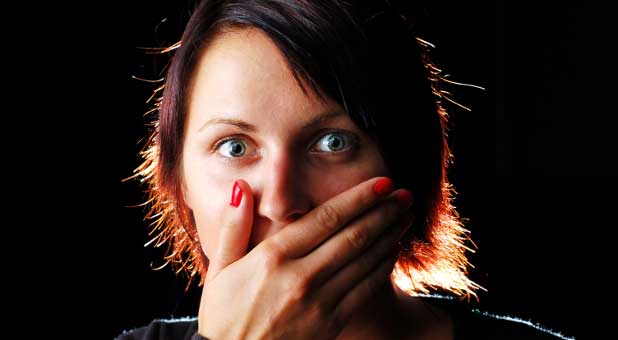 woman covering her mouth