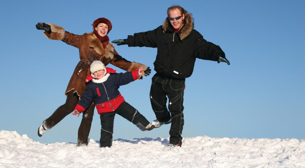 family playing in the snow