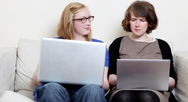 girl envying another girl's laptop