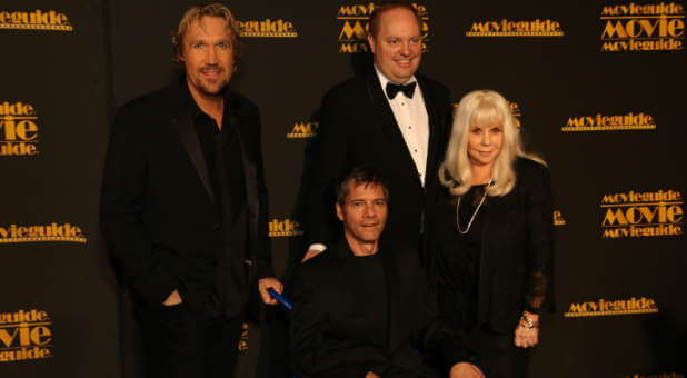 (From l to r) Movie Guide founding partners David A.R. White, Russell Wolfe (seated), Michael Scott and Elizabeth Travis.