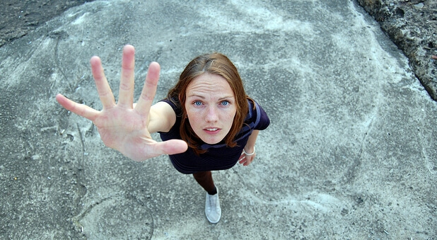 woman holding up hand