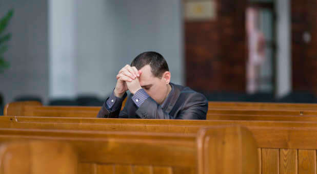 Man praying church