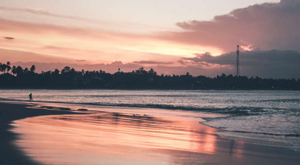 What she saw next was glorious: a picture of a beautiful ocean with a beach at sunset.